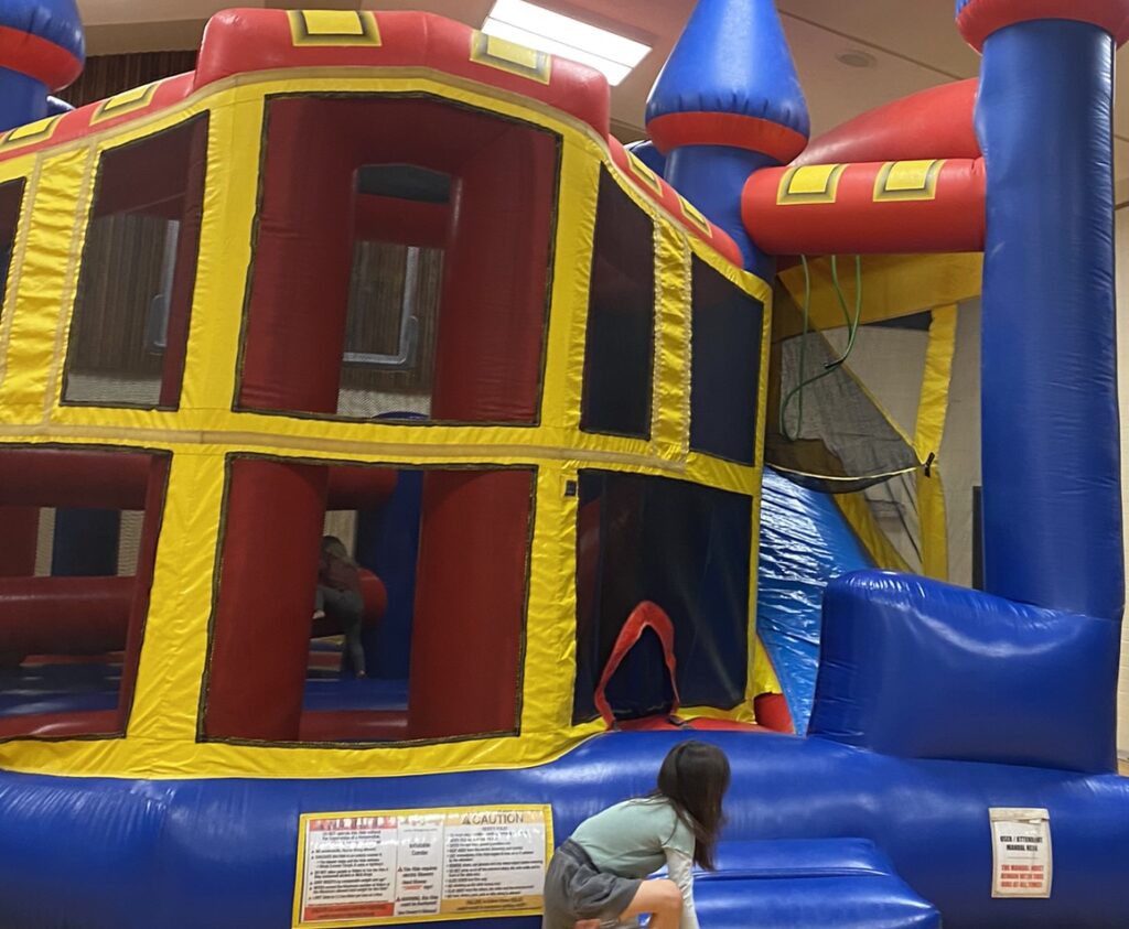 kids playing in a bounce house indoors